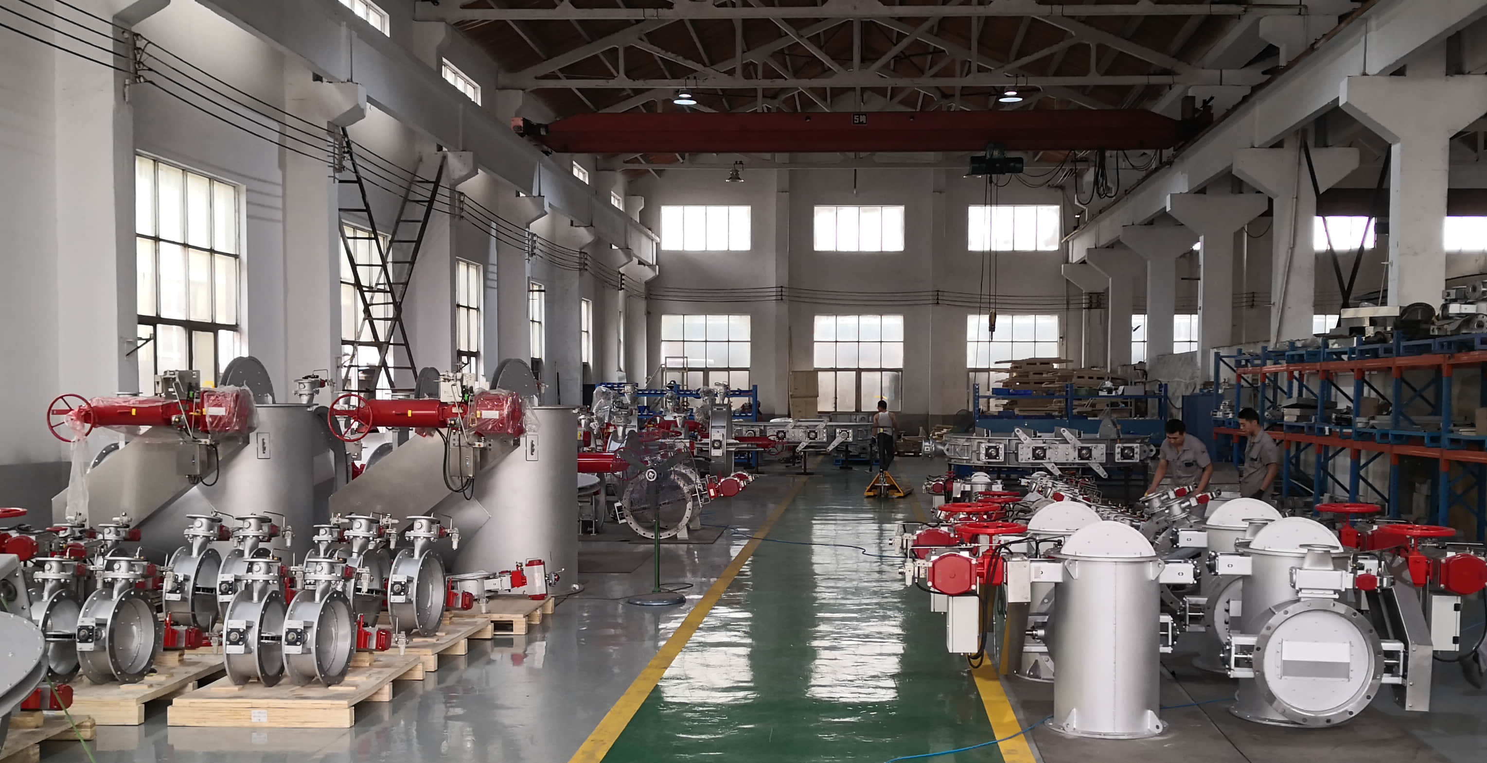 A large number of finished high-temperature industrial dampers are arranged in the workshop, showing FORENSERVTEK's batch production and delivery capacity.