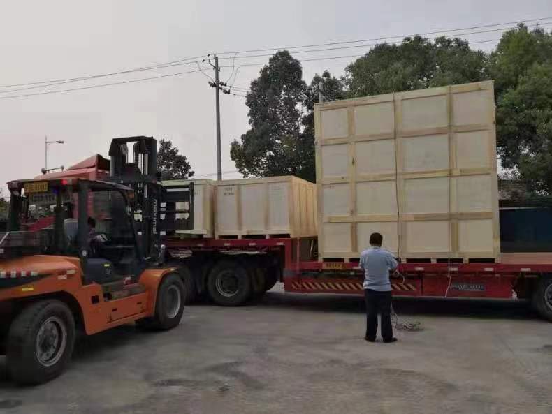 Crated industrial dampers are loaded for delivery from the FORENSERVTEK factory.