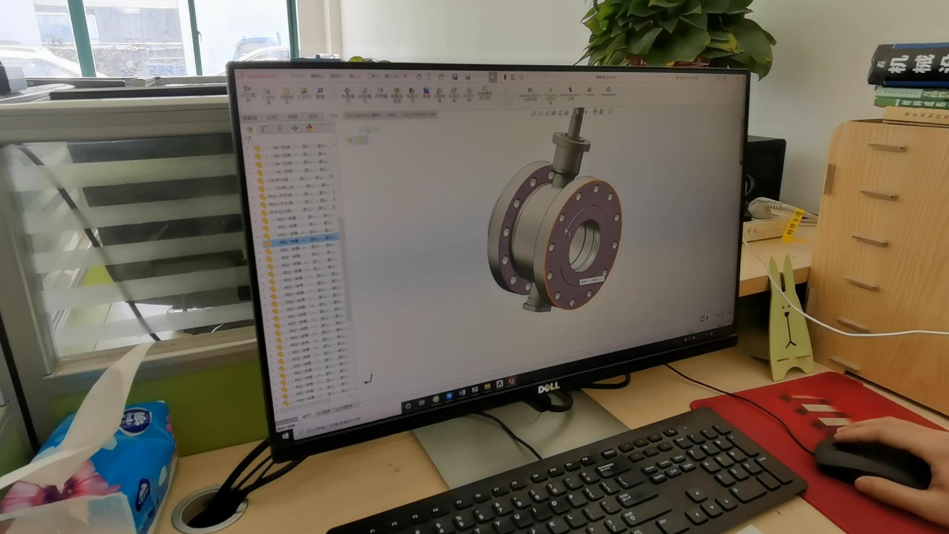 Technician designing an industrial damper in SolidWorks