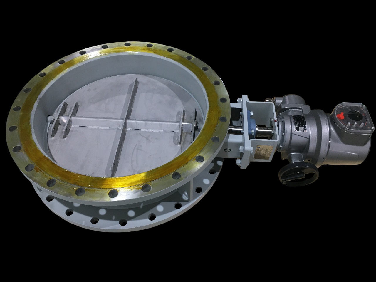 A double flanged round butterfly damper with an electric actuator and reinforced valve plate used for flue gas control in the process section of a petroleum heater