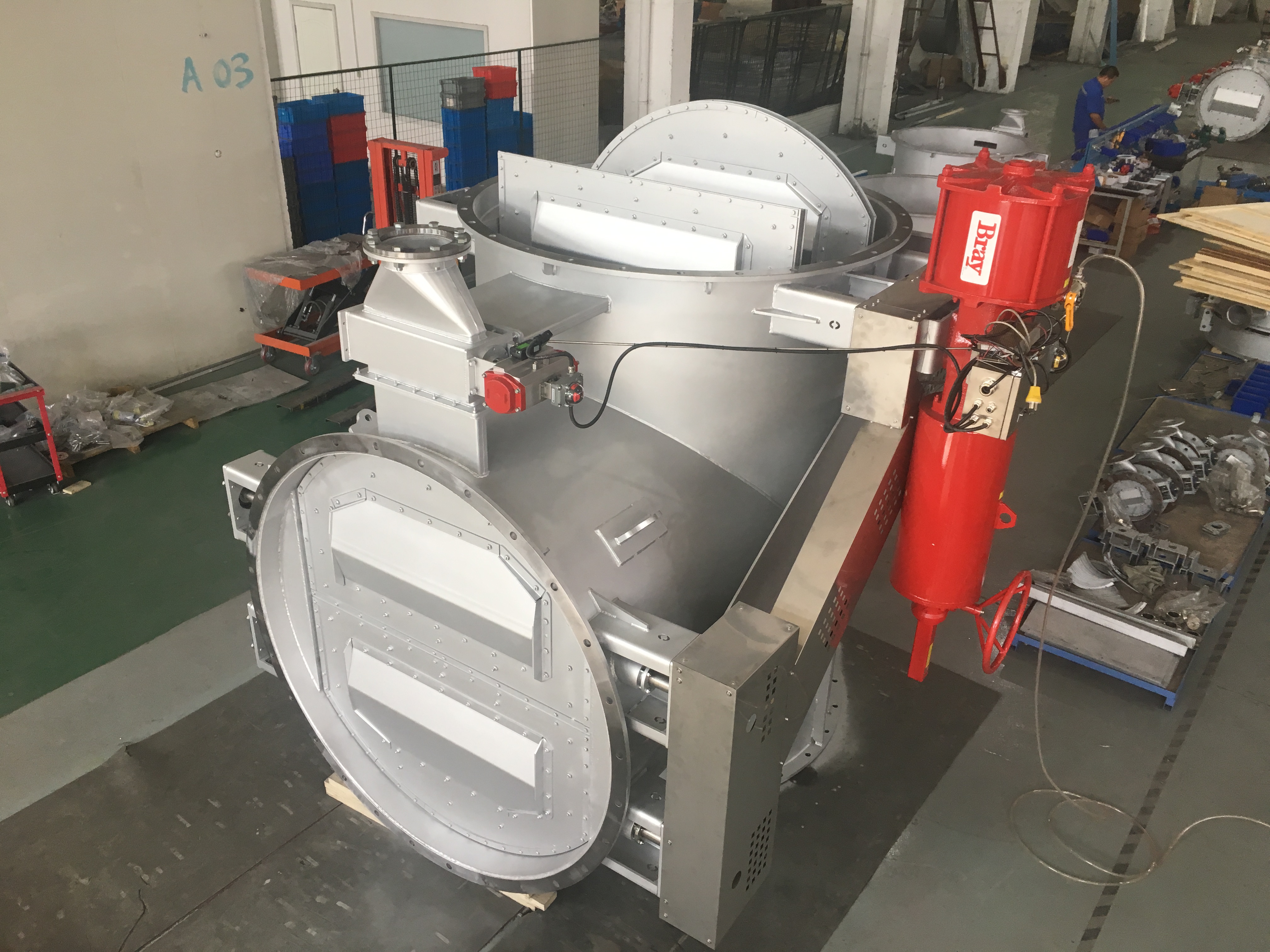 The large carbon steel three way flue gas diverter damper in the workshop is finished equipped with a pneumatic actuator and a position feedback switch used for flue gas bypass switching in power plant desulfurization