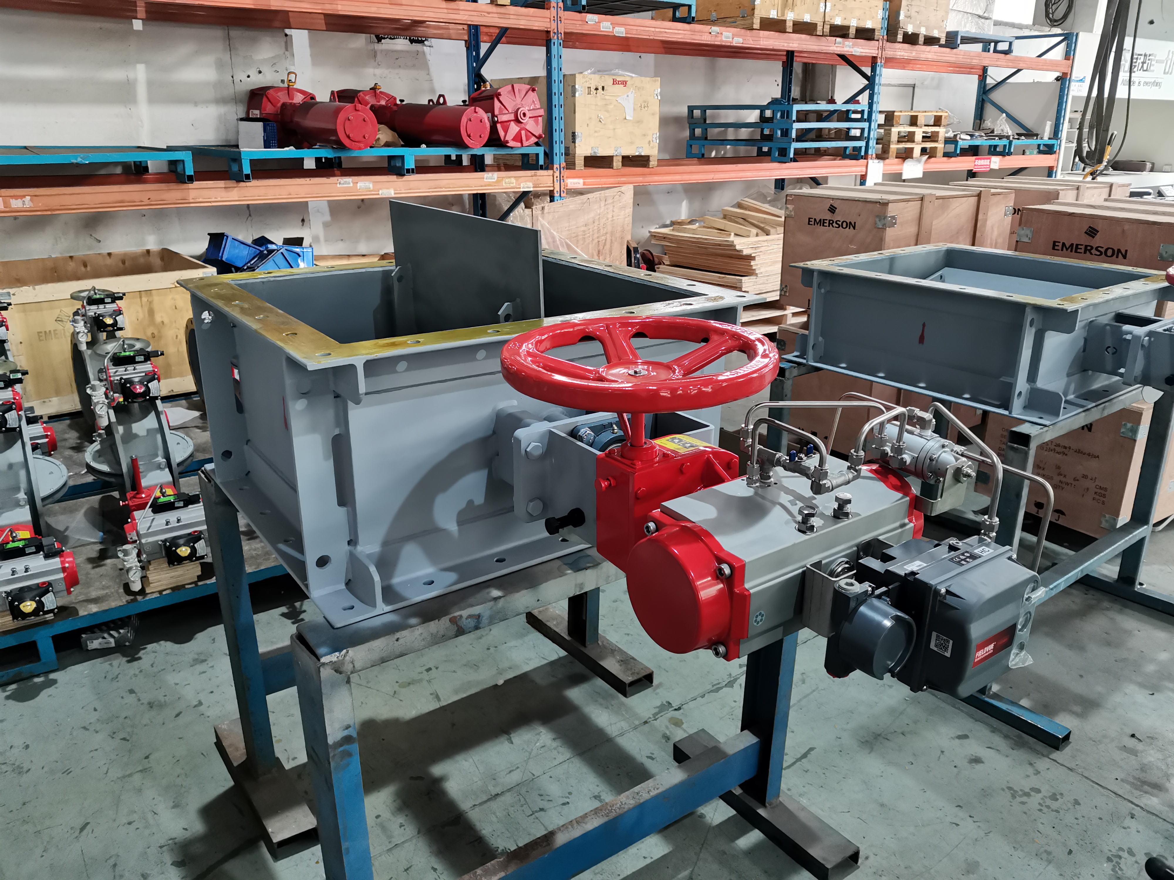 Finished rectangle pneumatic louver damper with a manual handwheel pneumatic actuator and positioner sitting on the workshop bench used to shut off flue gas in the desulfurization and dust removal industry