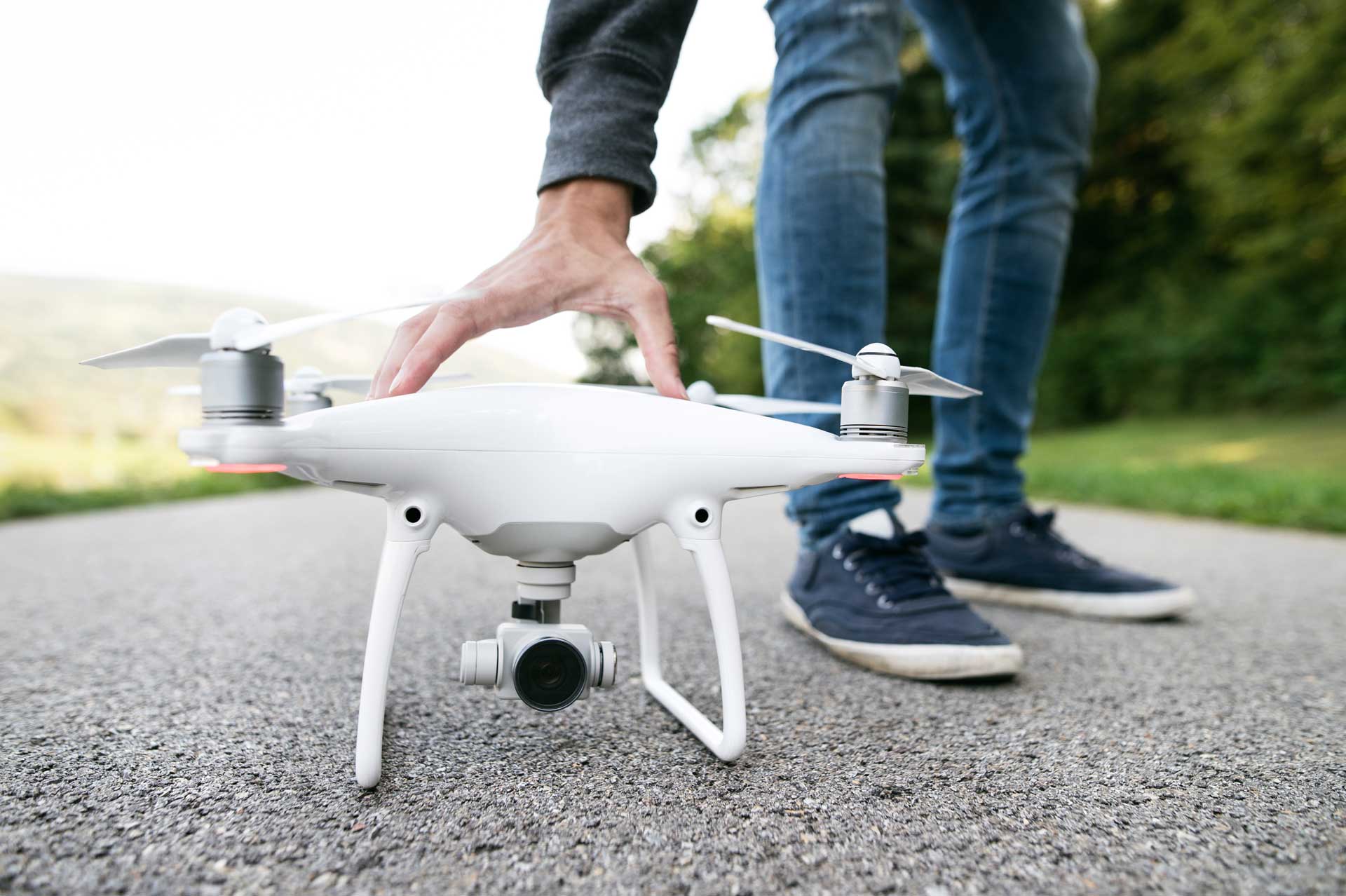 unrecognizable-man-with-drone-sunny-green-nature-c-PKFLLWC.jpg